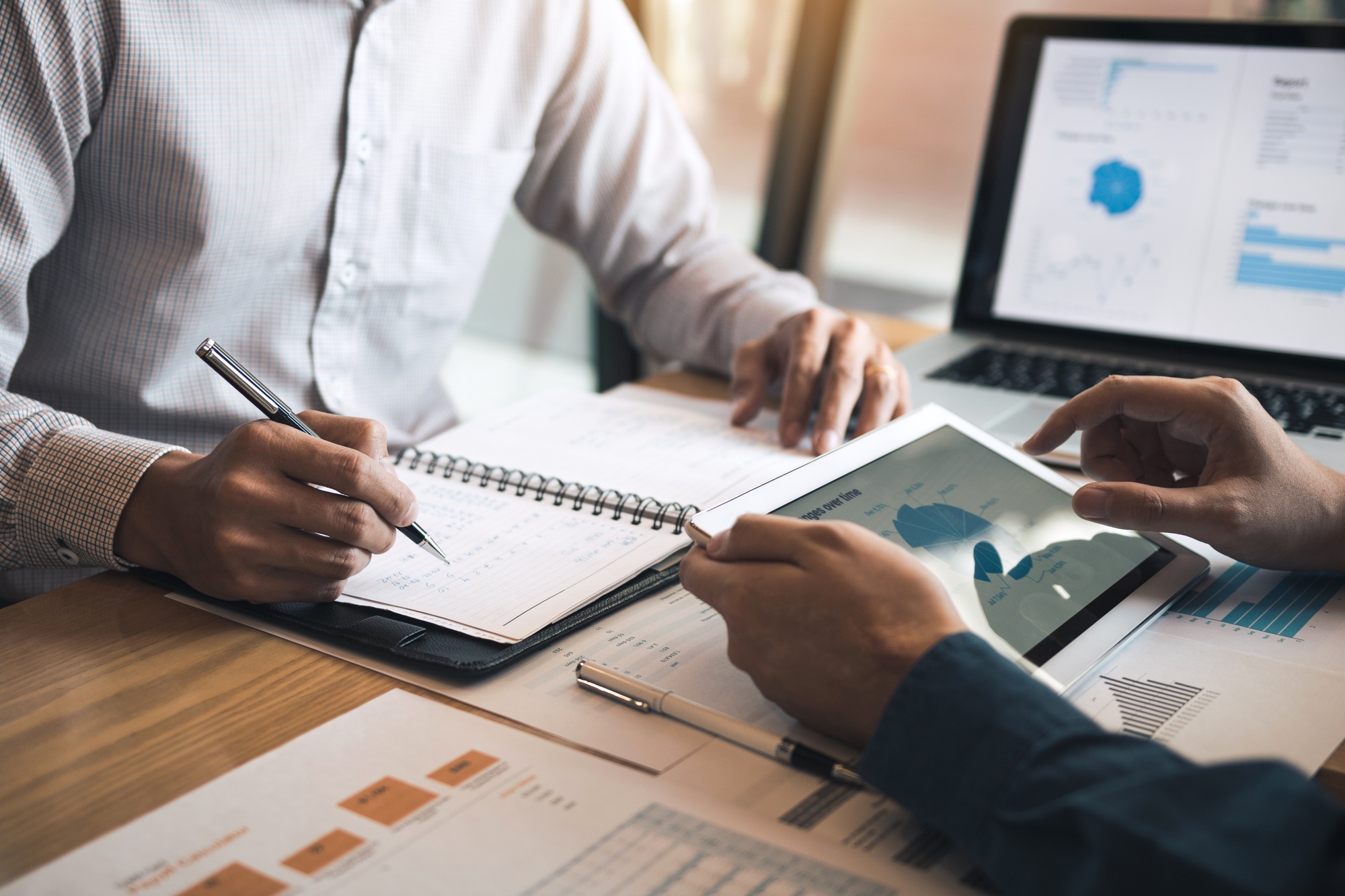 business partnership coworkers discussing a financial planning graph and company