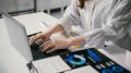 Businesswoman is working with financial data, analyzing charts and typing on a laptop, developing a