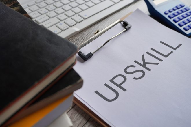 Closeup image of paper clipboard with text UPSKILL.