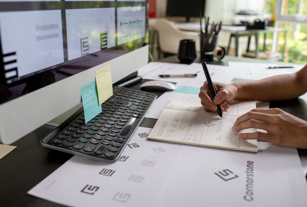 Graphic designer drawing sketches logo design.