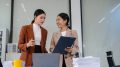 Team of businesswomen analyzing financial charts, planning company growth.