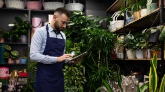 the owner of a potted plant shop doing inventory